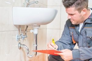 a plumber repairing a sink pipe