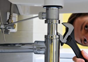 a plumber fixing a blocked drain in tiger point, florida