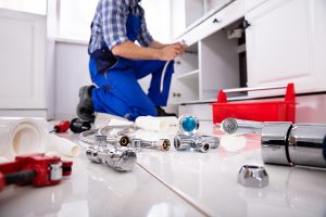 a plumber fixing a kitchen drain in whitfield fl