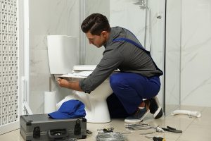 a plumber repairing a broken toilet